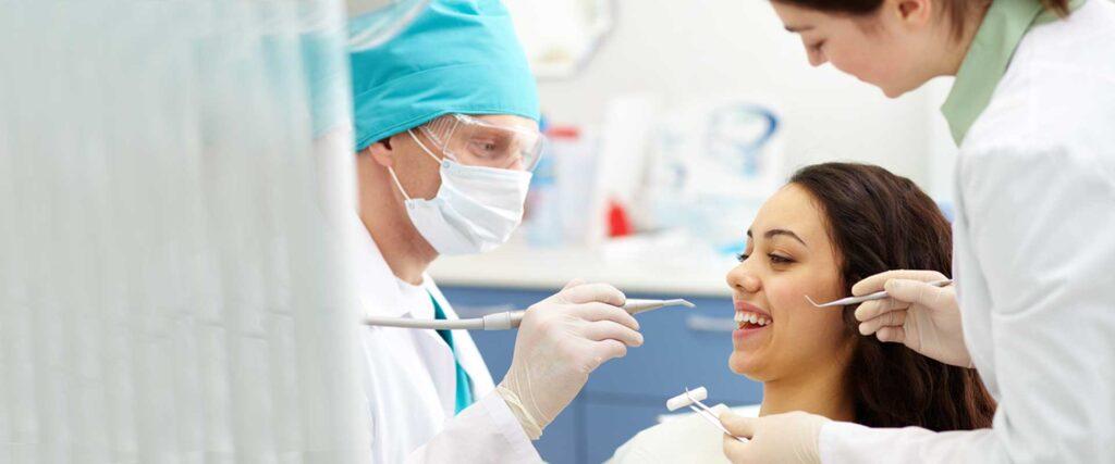 dentist-examining-patients-teeth - Kent Dentist