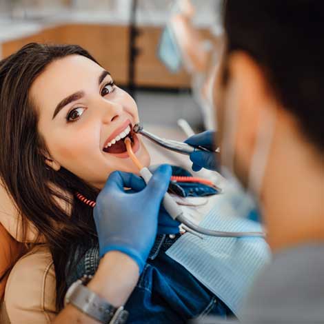 young-female-patient-visiting-dentist-office - Kent Dentist